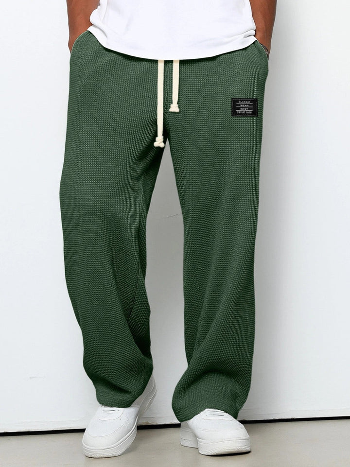 Relaxed fit men's drawstring sweatpants. Soft, comfortable, and versatile for active or casual wear.