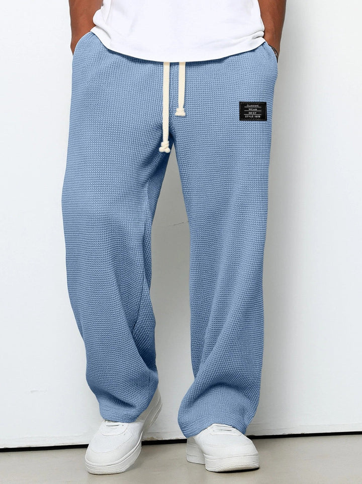 Men's drawstring jogging pants in a relaxed fit. Versatile comfort wear for gym or lounge.