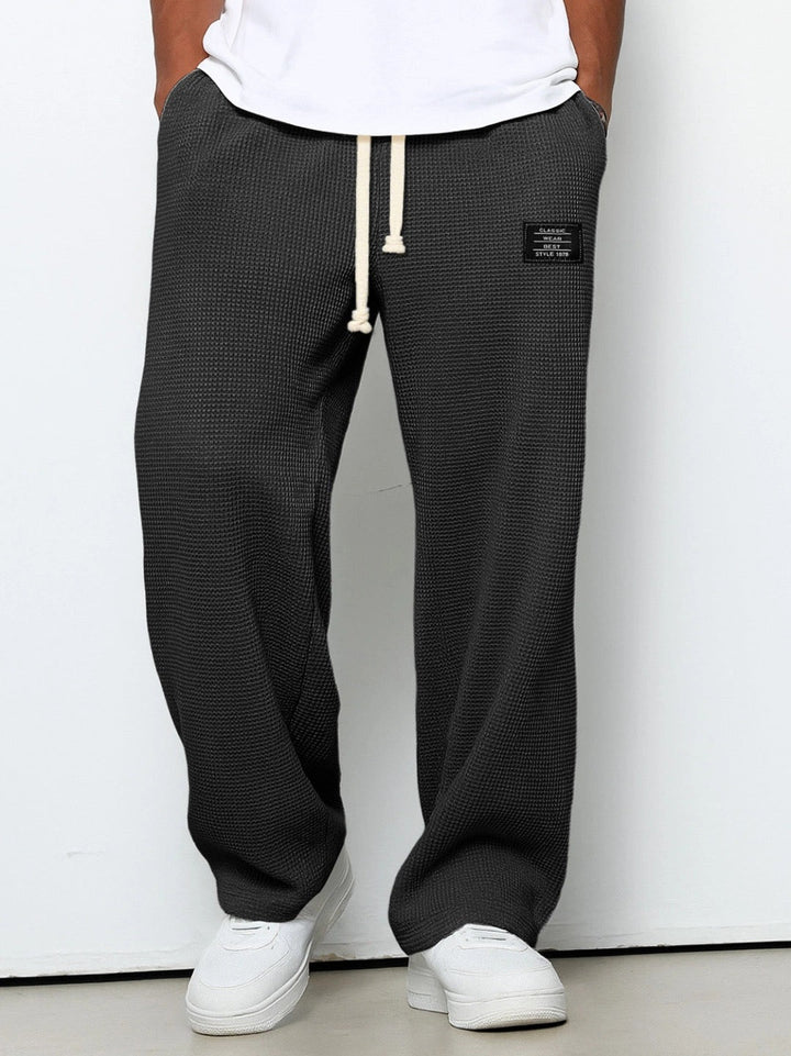 Close-up of soft textured men's jogging pants. Relaxed fit, ultimate comfort wear.