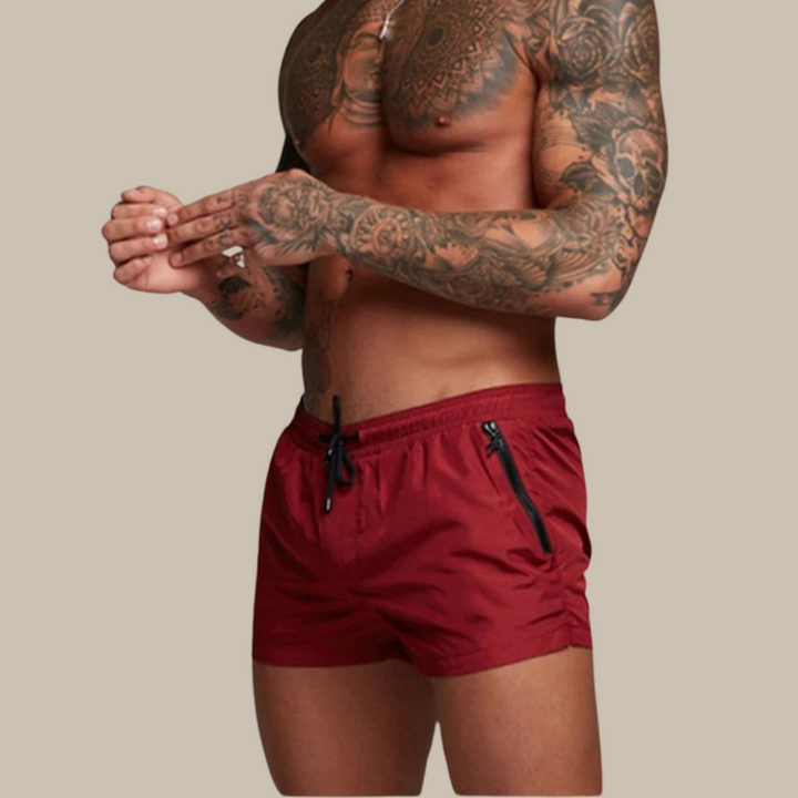 Men's quick-dry swim shorts with secure zipper pockets for beach & pool activities.