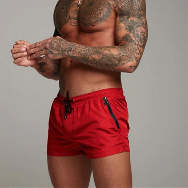 Secure men's swim shorts with zipper pockets for essentials, quick-drying for active beach days.