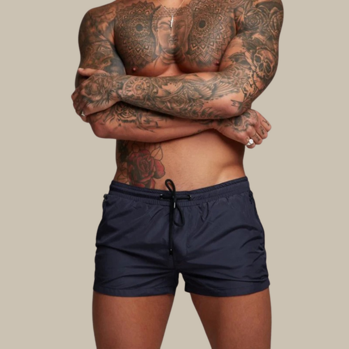 Modern men's quick-dry swimwear shorts featuring functional zipper pockets for convenience.