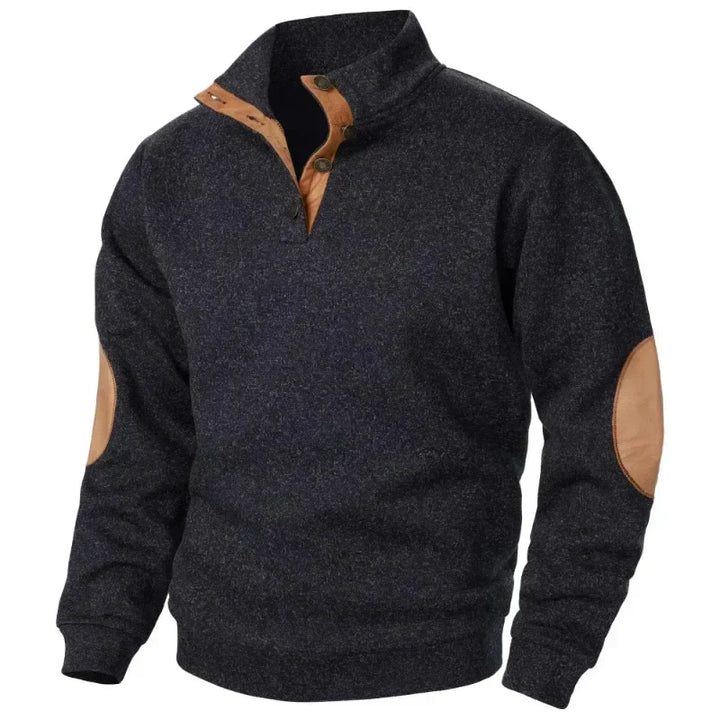 Model showing off the relaxed fit of a men's V-neck sweatshirt outdoors.