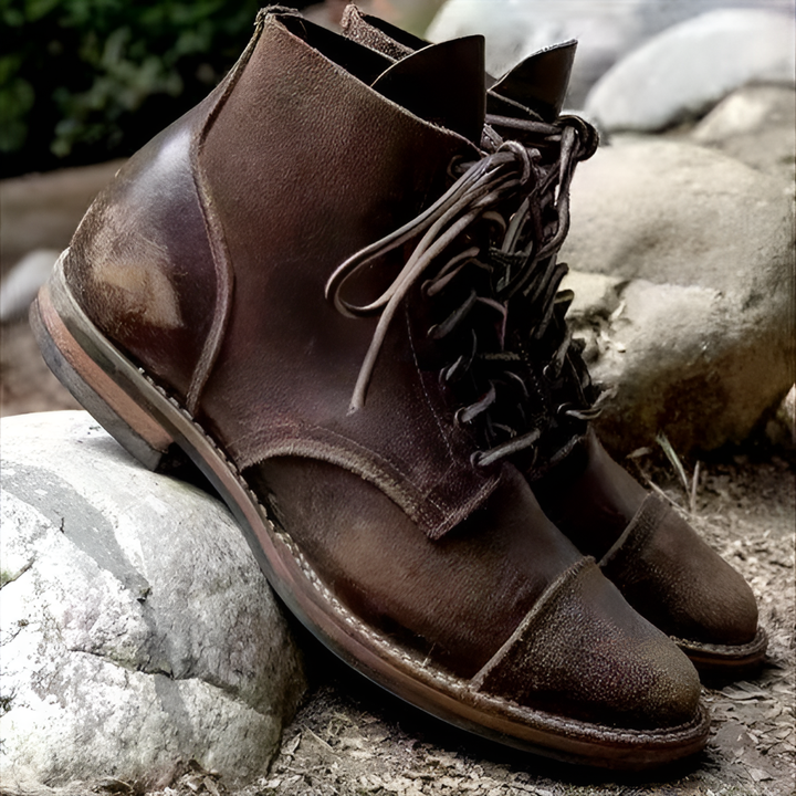 Close-up of men's lace-up boots showcasing detailed stitching and durable sole.