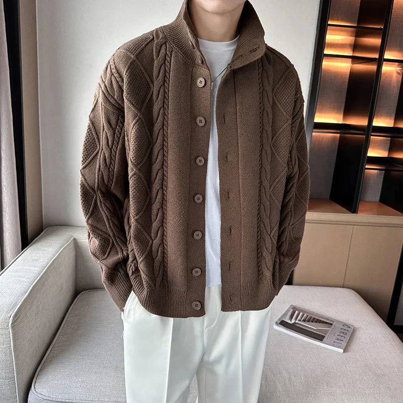 Close-up of a men's textured knit cardigan, featuring a button-up front and smart stand collar.
