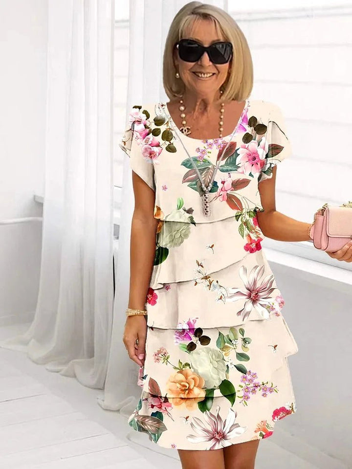 Gorgeous women's ruffled floral pleated dress, a flattering choice for any summer occasion or elegant party.