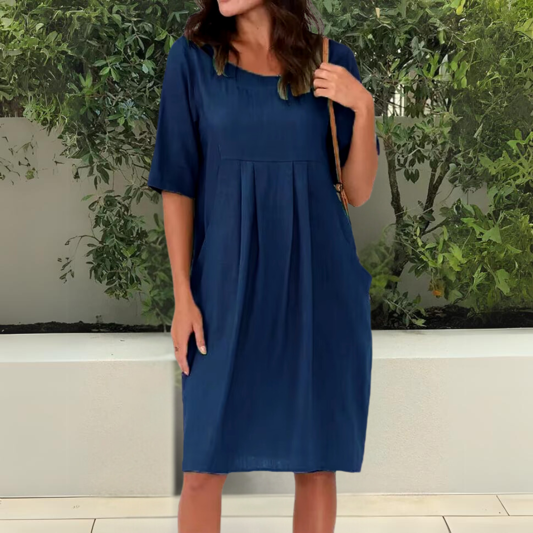 Comfortable women's midi dress, relaxed fit, half sleeve, scoop neck, and pockets for versatile casual elegance.