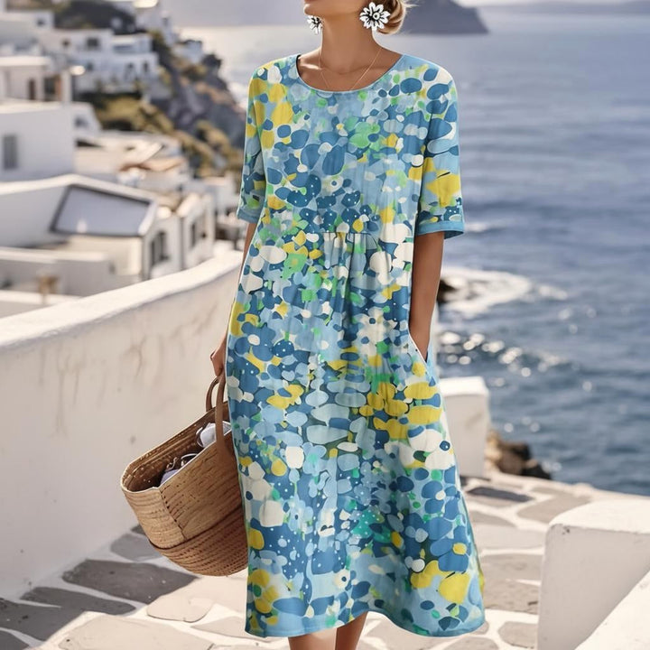 Women's blue abstract floral midi dress with short sleeves, perfect for a wedding guest or summer party.