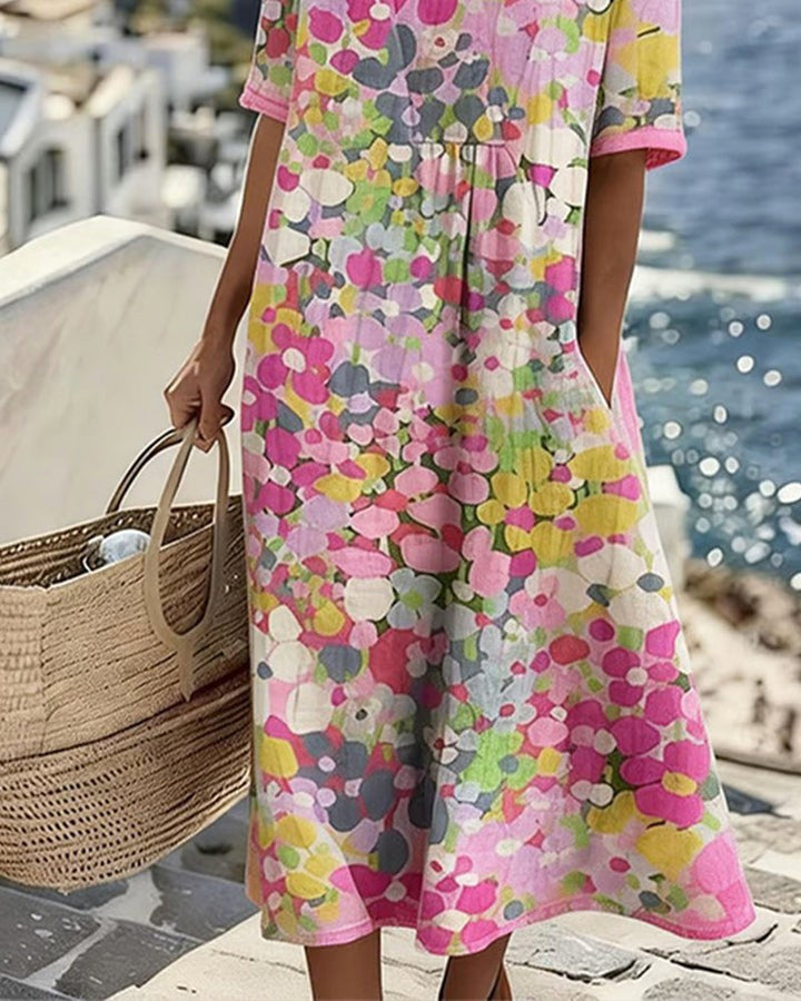 Women's comfortable midi dress featuring a vibrant abstract floral print and practical pockets.