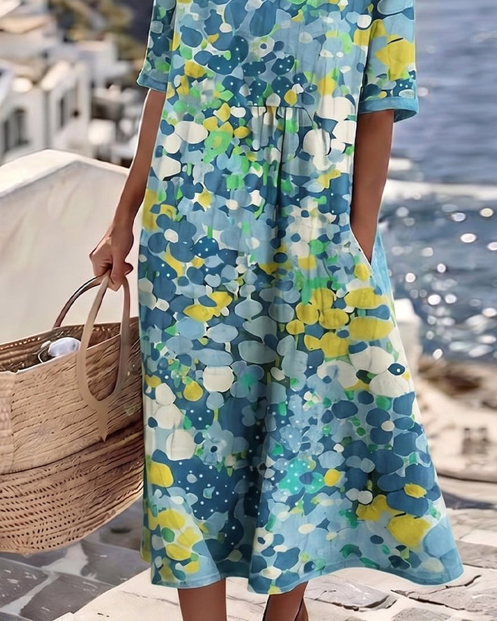 Casual women's floral midi dress, abstract design, with pockets, for a comfortable summer outfit.