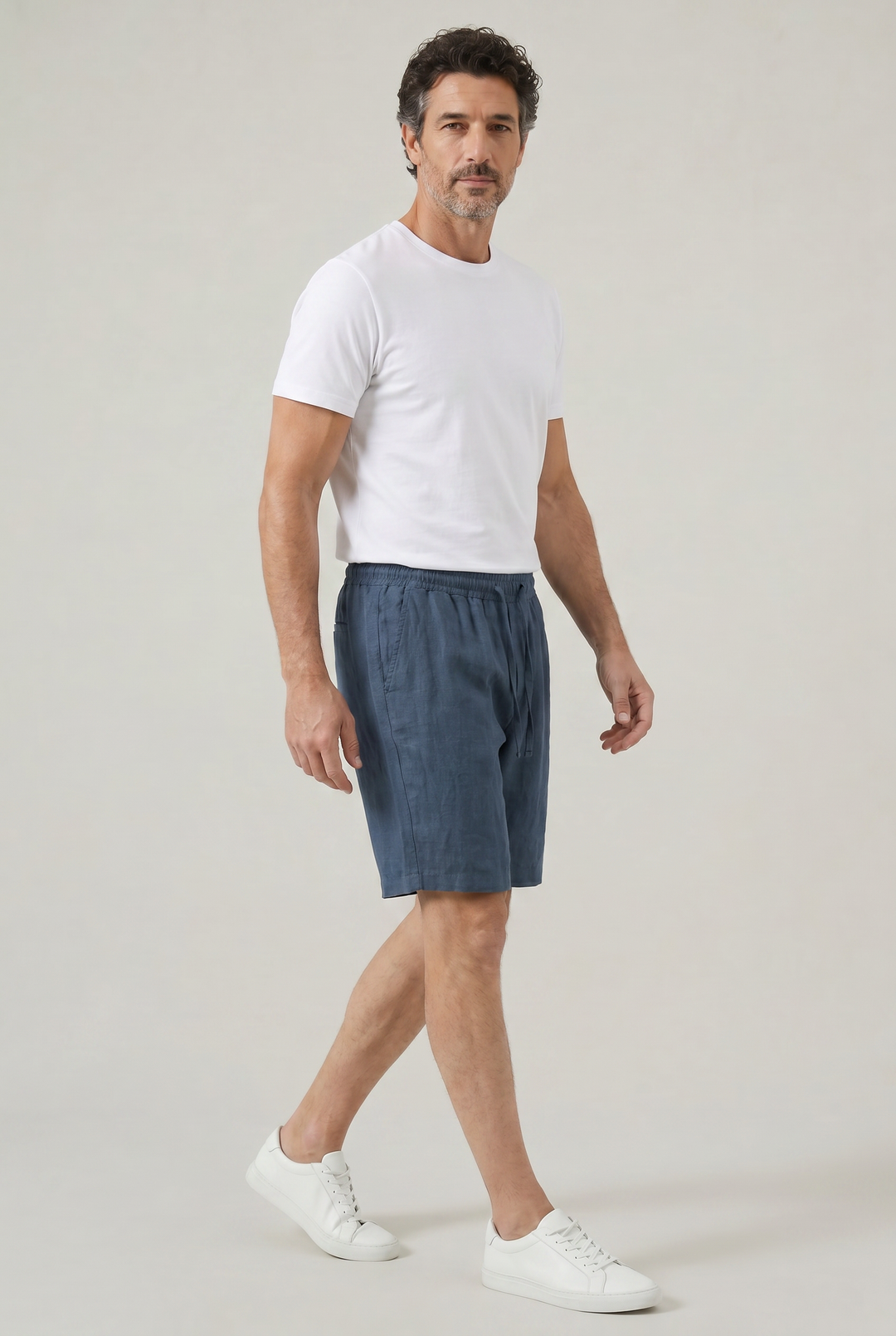 Effortless navy linen men's shorts, knee-length with elastic drawstring waist for ultimate comfort & relaxed summer style.
