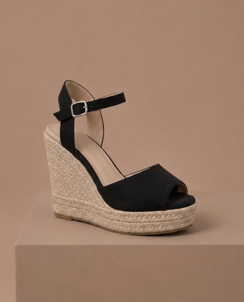 Close-up of chic women's braided espadrille wedge sandal with ankle strap, highlighting the texture.