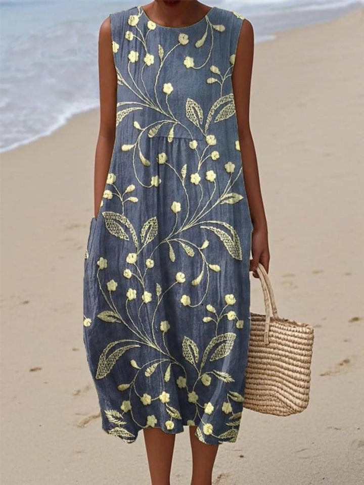 Women's effortless floral sleeveless midi dress for casual summer outings. Comfortable swing style with a vibrant print.