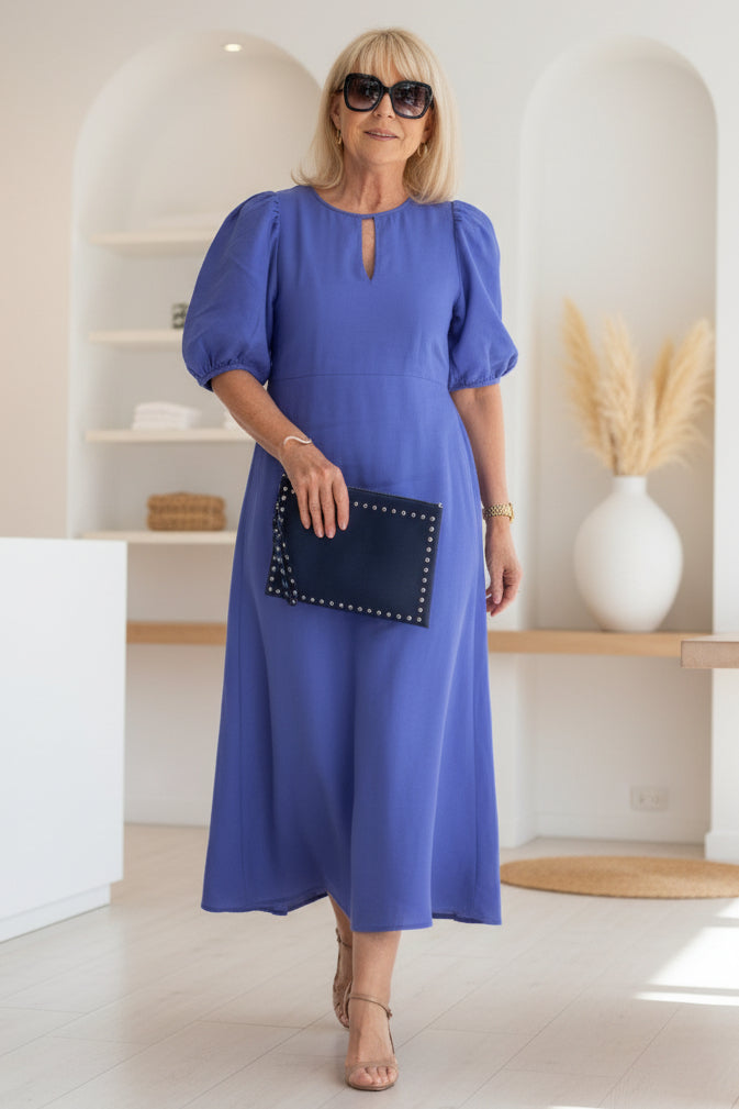 Chic women's elegant midi cocktail dress featuring dramatic puff sleeves, perfect for evening wear.
