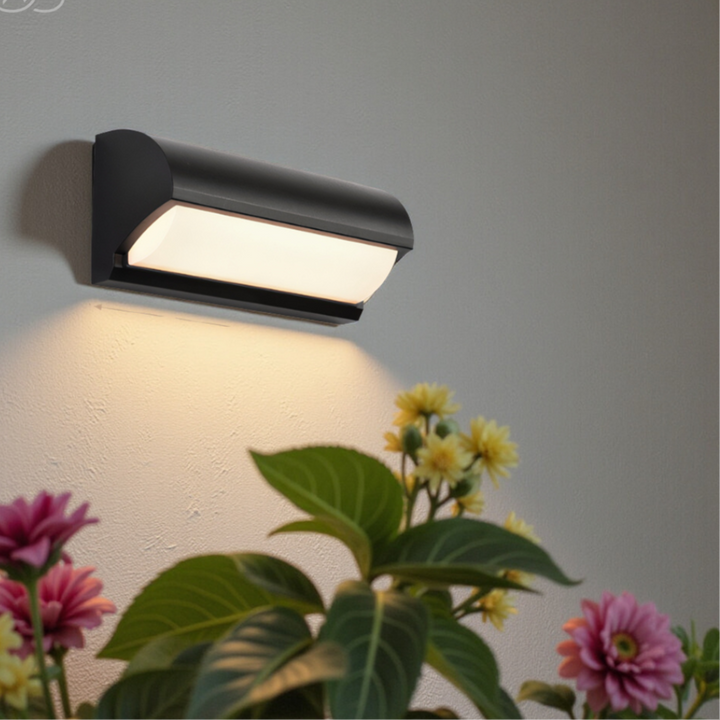 Stylish black modern LED wall light, ideal for entryway, garden, and patio outdoor lighting. Energy efficient.
