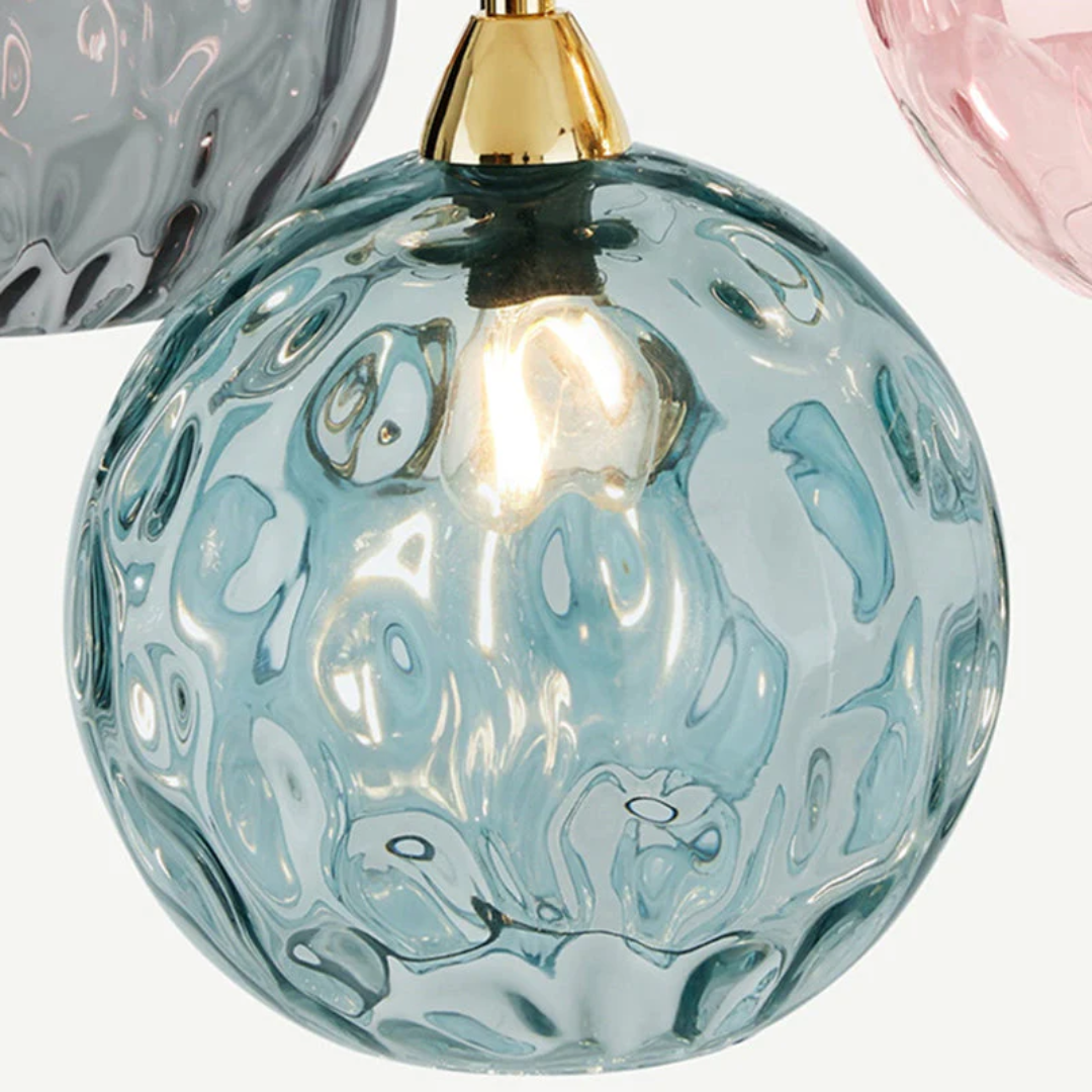 Sophisticated 3-lamp cluster pendant, modern lighting fixture enhances home decor.