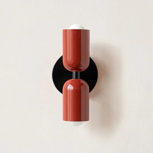 Adjustable LED wall lamp illuminating a bedroom, offering versatile indoor lighting.