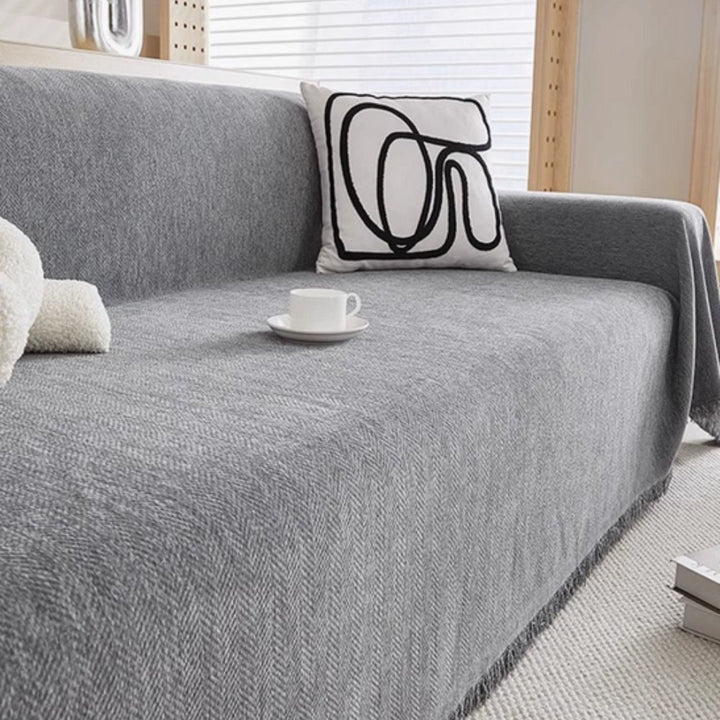 Soft, pet-friendly throw blanket protecting a modern sofa, ideal as a furniture protector and easy care couch cover.