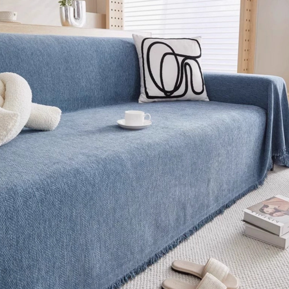Minimalist-style throw blanket in a neutral tone draped over a sofa, enhancing living room decor with a modern home accent.