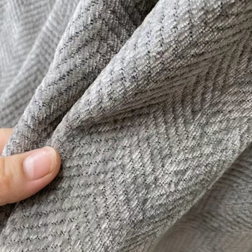 Cozy modern design throw blanket, beautifully accenting a living room sofa, offering comfort and furniture protection.
