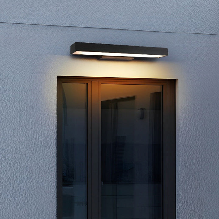 Sleek black LED wall lamp with motion sensor, ideal for modern outdoor security lighting.