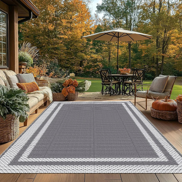 Outdoor decor: modern gray rectangular patio mat, reversible & water-resistant, stylish geometric design.