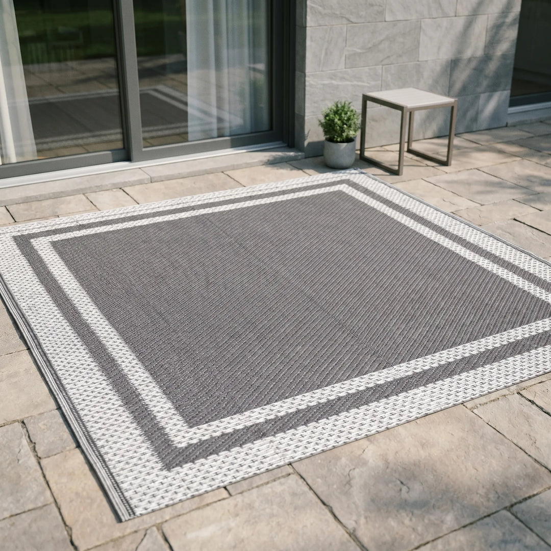 Portable outdoor rug: modern gray rectangular mat for patio, deck, or camping, water-resistant.