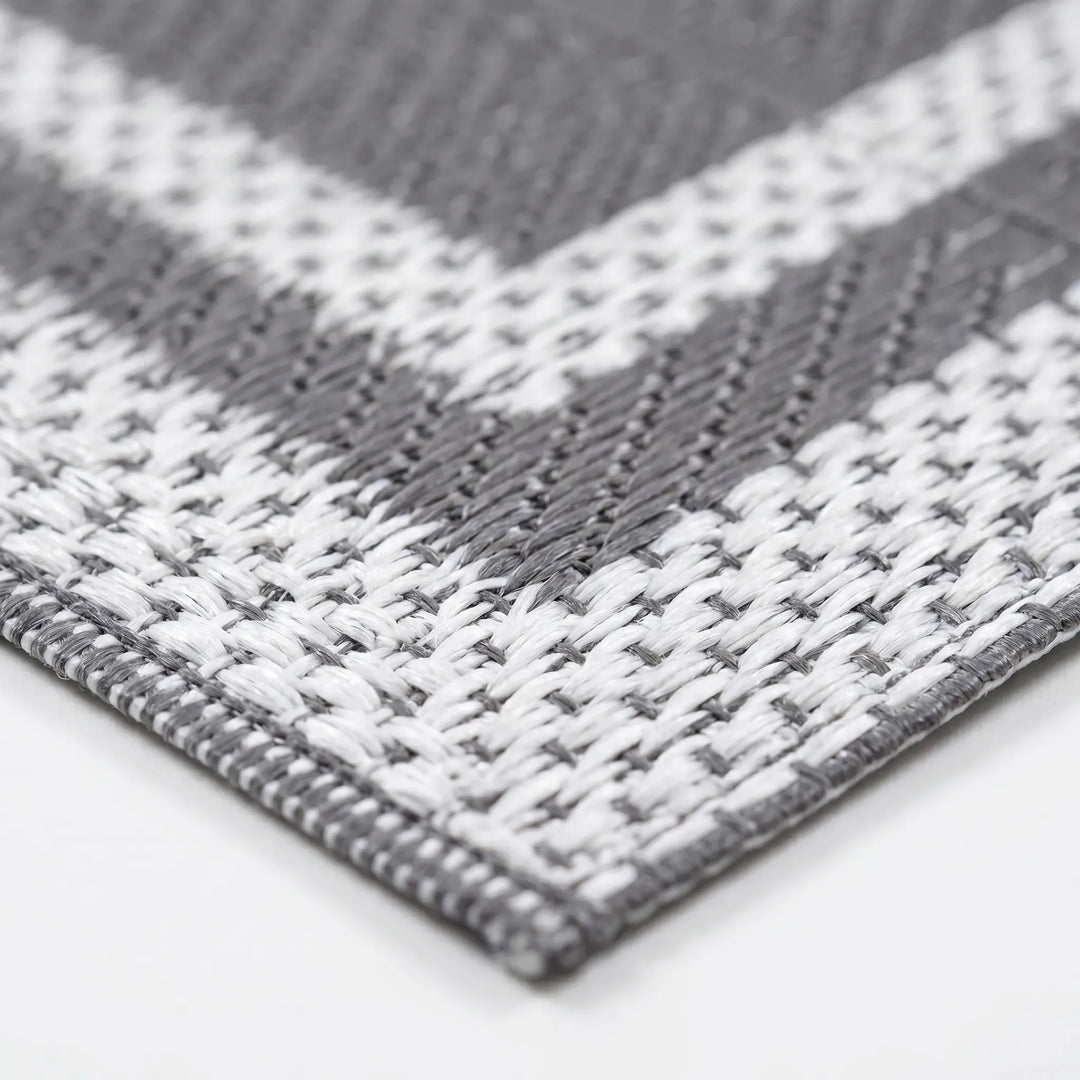 Stylish gray outdoor mat, modern geometric reversible design, perfect rectangular rug for deck or patio.