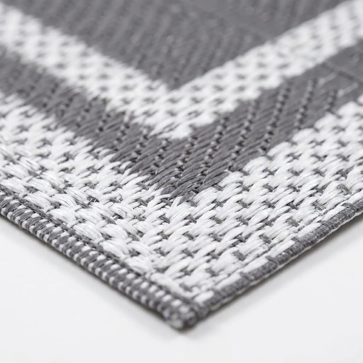 Stylish gray outdoor mat, modern geometric reversible design, perfect rectangular rug for deck or patio.