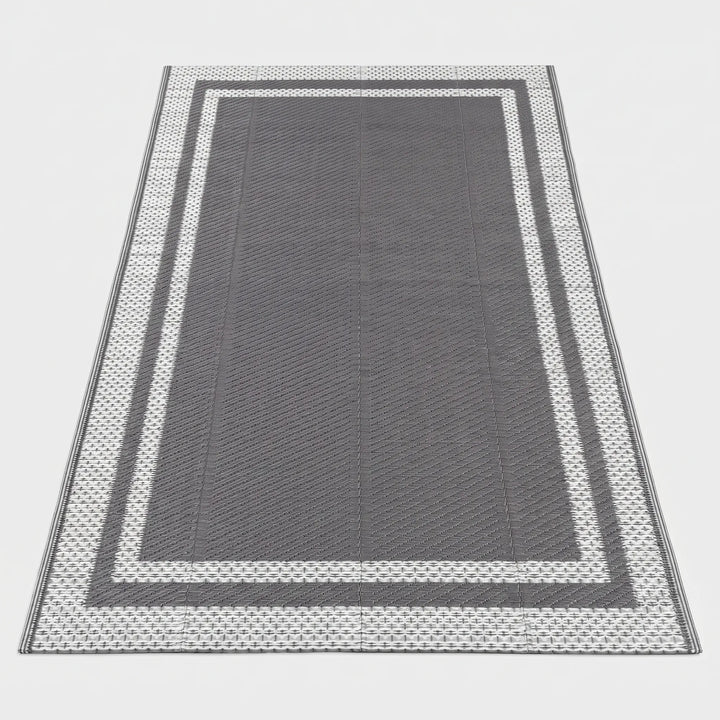 Durable rectangular outdoor patio mat, water-resistant, modern geometric gray design for deck decor.