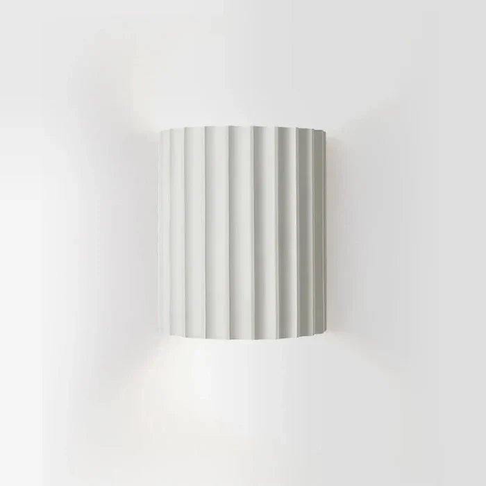 Modern resin wall lamp with artistic wave design. Contemporary LED lighting for home decor.