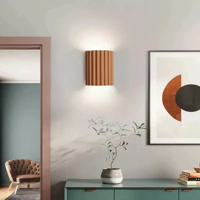 Contemporary wall light, featuring a unique artistic wave design made from resin. Modern home decor.