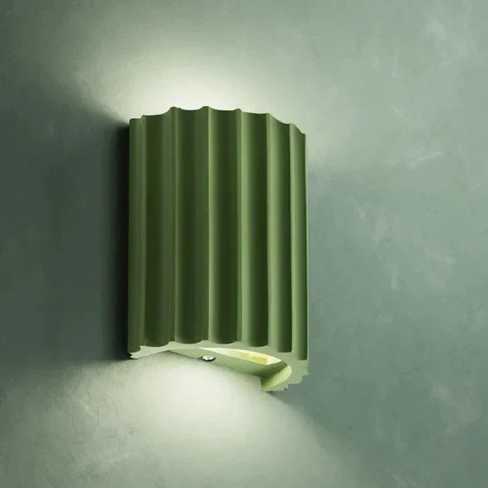 Intricate artistic wave design resin wall light. Provides modern LED illumination for home decoration.