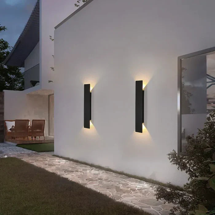 Sleek black StormGlow modern outdoor wall lamp with up/down light, ideal for architectural exterior lighting.