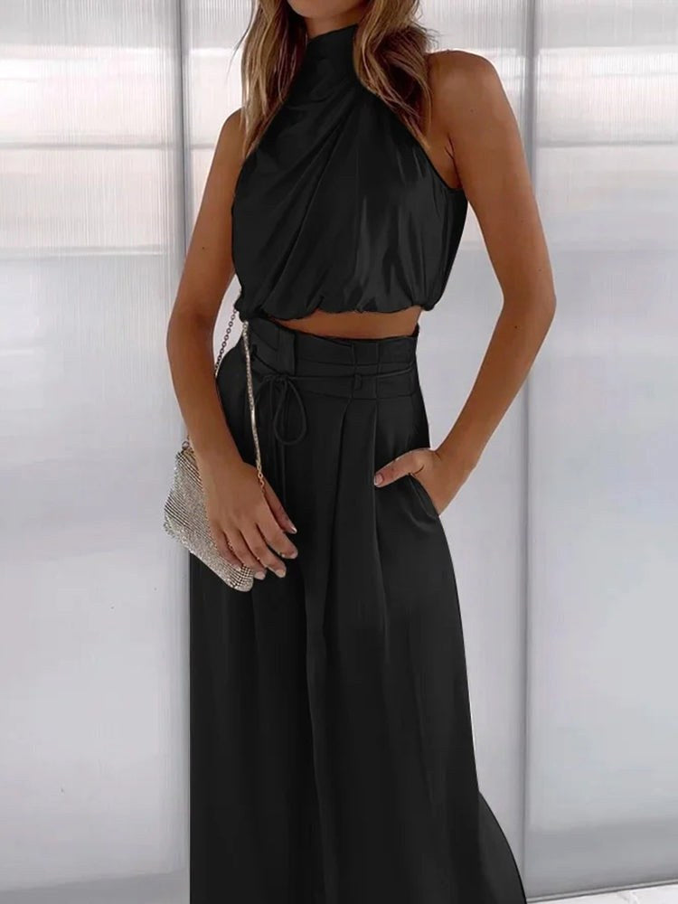 Sleek women's two-piece set: elegant halter neck top and flattering wide-leg pants design.