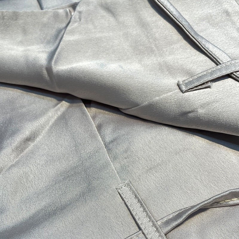 Women's comfortable elegant suit with a halter neck top and flowing wide-leg trousers.