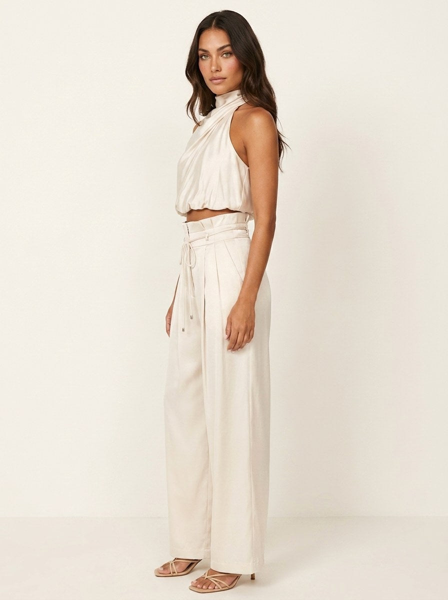 Stylish women's evening outfit: halter neck top and wide-leg trousers two-piece set.
