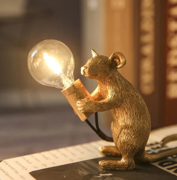 Unique decorative gold mouse accent lamp, artistic & whimsical bedside/desk light for home decor.