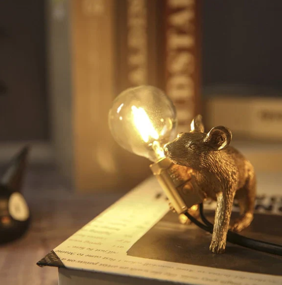Whimsical gold mouse desk lamp with white shade, a unique animal table light for artistic home decor.