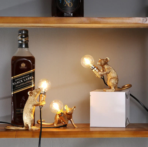 Decorative gold mouse table lamp with white shade, a charming accent light for whimsical home decor.