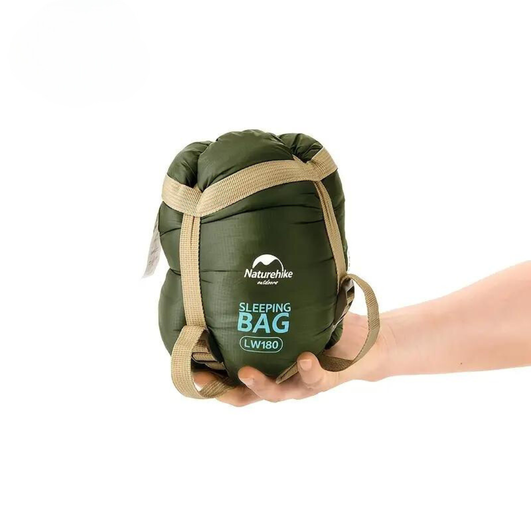 Green compact sleeping bag for camping. Warm & lightweight outdoor gear for adventures.