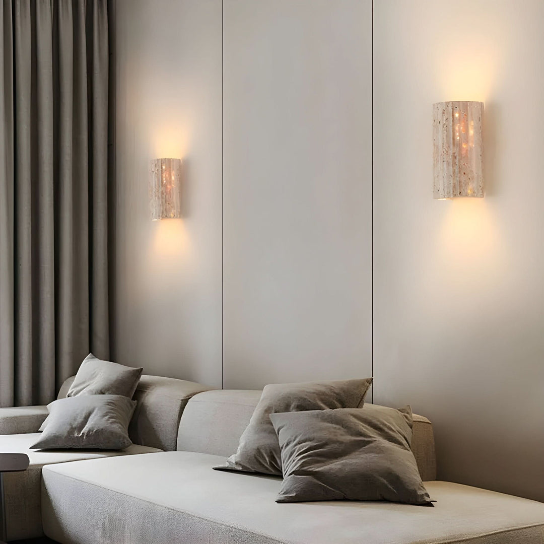Modern LED wall sconce with natural stone finish, providing soft, ambient accent lighting for home.