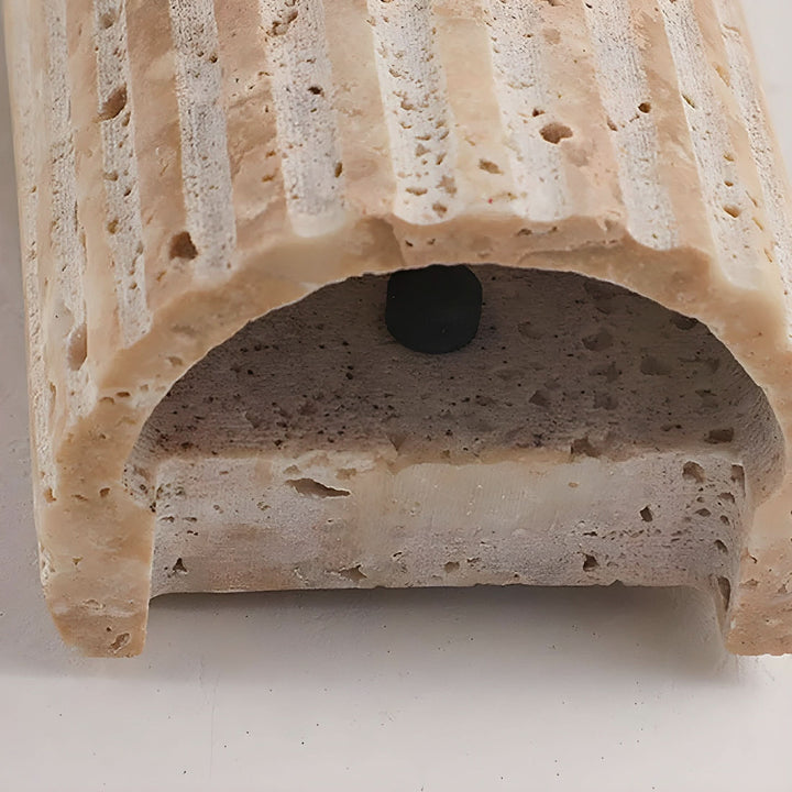 Energy-efficient modern LED wall sconce, crafted from natural stone, adds elegant interior lighting to any room.