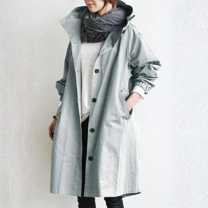 Women's waterproof rain jacket featuring an adjustable hood, sleek design, and practical pockets for urban style.