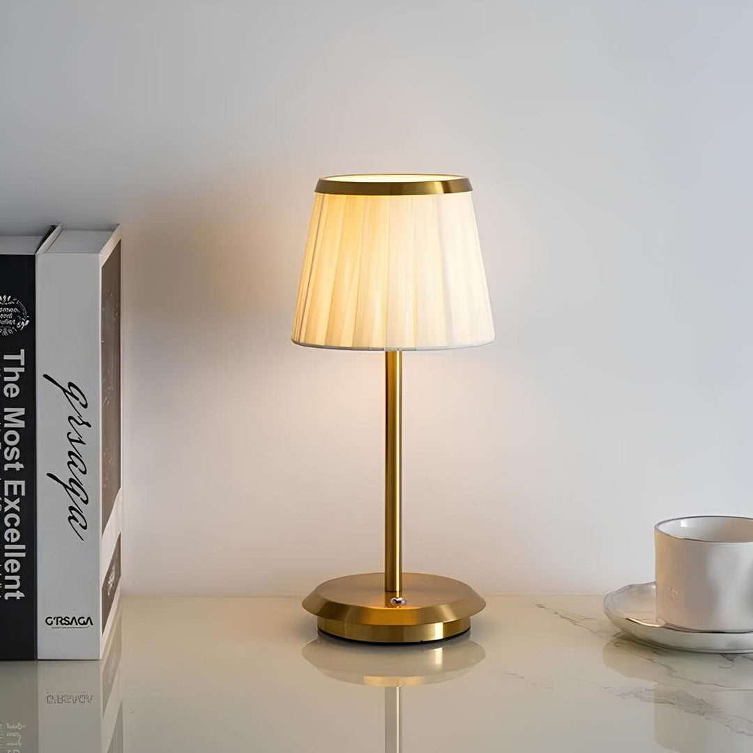 Modern elegant table lamp. Fabric shade, brass base, dimmable LED. Classic design with touch control for sophisticated decor.