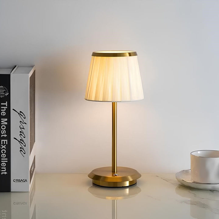 Modern elegant table lamp. Fabric shade, brass base, dimmable LED. Classic design with touch control for sophisticated decor.