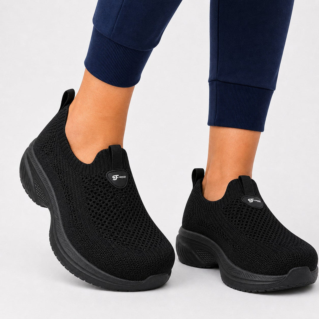 Women's black wide toe slip-on shoes with arch support & comfort for active lifestyles.