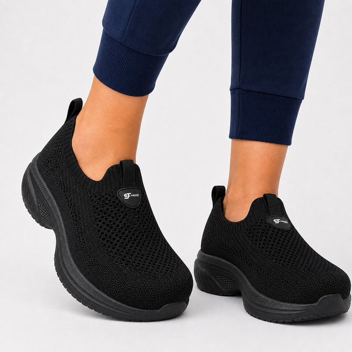 Women's black wide toe slip-on shoes with arch support & comfort for active lifestyles.