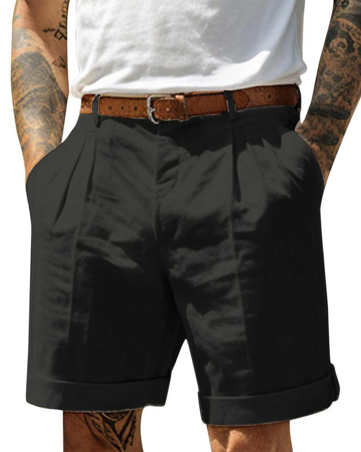 Tailored men's pleated chino shorts offering refined comfort for warm weather. Ideal for smart casual summer outfits.