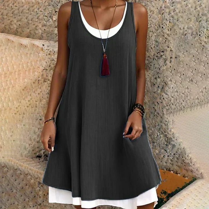 Chic women's layered sleeveless mini dress with round neck, perfect for summer casual wear.